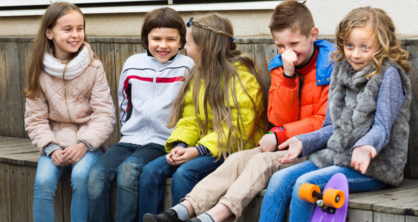 Group Of Children Sitting On Bench