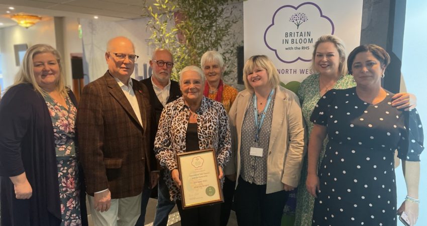 Britain In Bloom Team on stage with their certificate